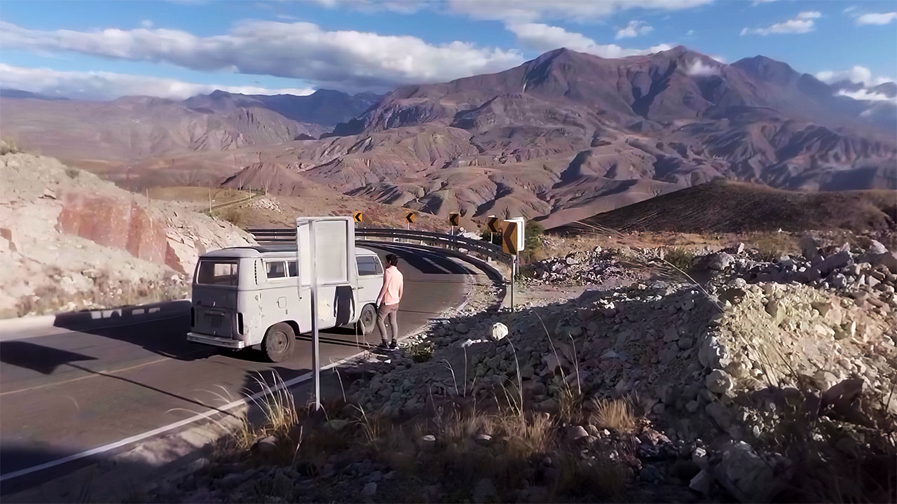 A white van on a switchback road high in the Andes