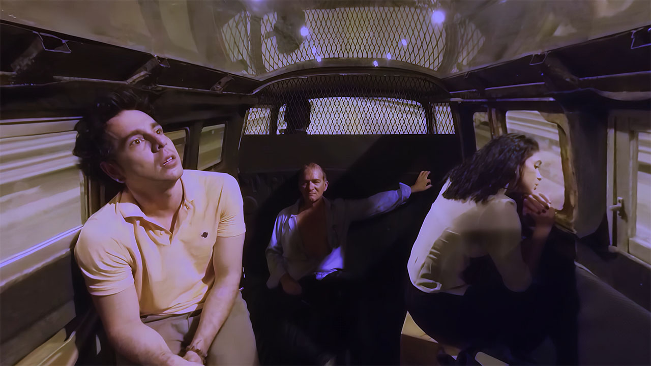 The passengers inside the van bathed in violet dream-light