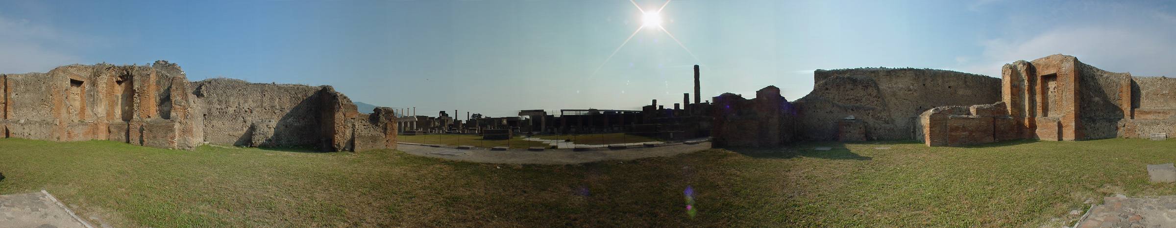 A 360° panorama of the Forum of Pompeii: an open civic plaza ringed by column bases and ruined temples under an open sky.